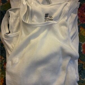 Six White Ribbed Tank Tops